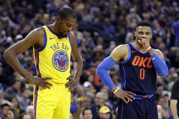 Golden State Warriors' Kevin Durant, left, stands next to Oklahoma City Thunder's Russell Westbrook during the first half of an NBA basketball game Saturday, Feb. 24, 2018, in Oakland, Calif. (AP Photo/Marcio Jose Sanchez)