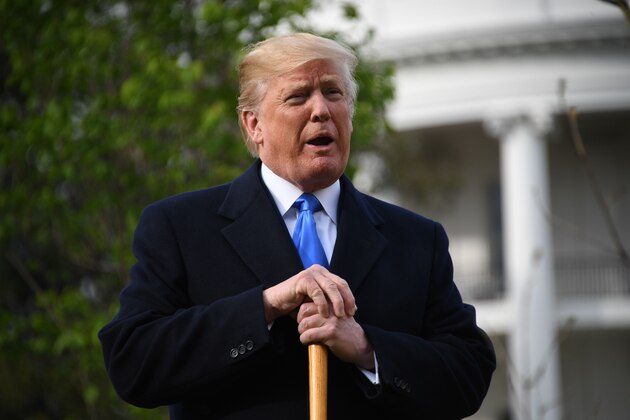 US President Donald Trump speaks during a tree planting ceremony with French President Emmanuel Macron, Melania Trump and Macron's wife Brigitte on the grounds of the White House April 23, 2018 in Washington,DC. (Photo by JIM WATSON / AFP)        (Photo credit should read JIM WATSON/AFP/Getty Images)