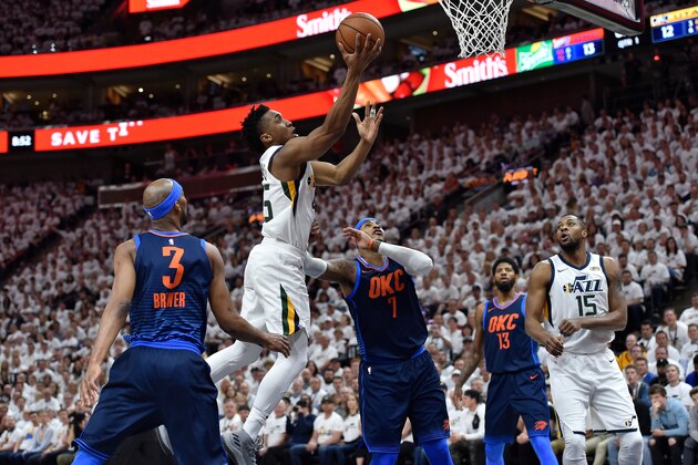 SALT LAKE CITY, UT - APRIL 23: Donovan Mitchell #45 of the Utah Jazz goes to the basket past Carmelo Anthony #7 of the Oklahoma City Thunder in the first half during Game Four of Round One of the 2018 NBA Playoffs at Vivint Smart Home Arena on April 23, 2018 in Salt Lake City, Utah. NOTE TO USER: User expressly acknowledges and agrees that, by downloading and or using this photograph, User is consenting to the terms and conditions of the Getty Images License Agreement. (Photo by Gene Sweeney Jr./Getty Images)