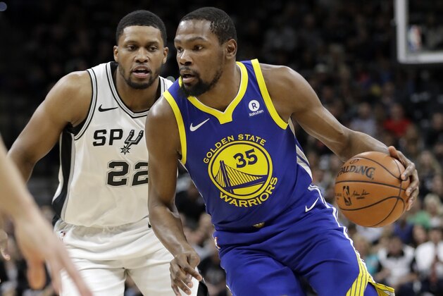 San Antonio Spurs' Rudy Gay (22) defends as Golden State Warriors' Kevin Durant (35) advances the ball up court in the first half of Game 3 of a first-round NBA basketball playoff series in San Antonio, Thursday, April 19, 2018. (AP Photo/Tony Gutierrez)