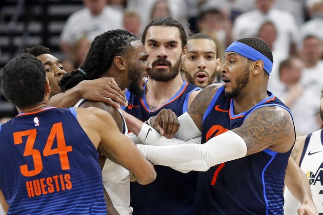Utah Jazz forward Jae Crowder, left, and Oklahoma City Thunder forward Carmelo Anthony, right, are separated in the second half during Game 4 of an NBA basketball first-round playoff series, Monday, April 23, 2018, in Salt Lake City. Crowder was ejected from the game. Utah went on to win 113-96. (AP Photo/Rick Bowmer)