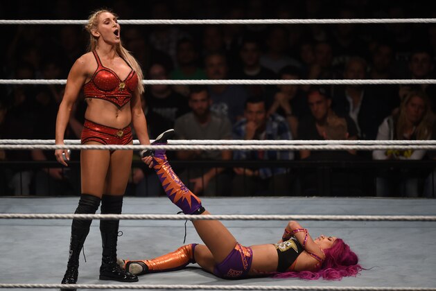 WWE wrestling stars Sasha Bank (R) and Charlotte Flair (L) fight during a WWE (World Wrestling Entertainment) women's fight at the Olympic hall in Munich, southern Germany, on November 3, 2016.  / AFP / CHRISTOF STACHE        (Photo credit should read CHRISTOF STACHE/AFP/Getty Images)