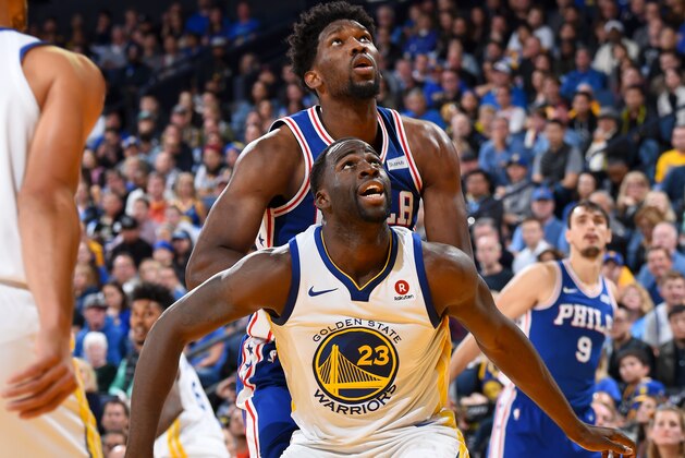 OAKLAND, CA - NOVEMBER 11:  Draymond Green #23 of the Golden State Warriors boxes out Joel Embiid #21 of the Philadelphia 76ers on November 11, 2017 at ORACLE Arena in Oakland, California. NOTE TO USER: User expressly acknowledges and agrees that, by downloading and or using this photograph, user is consenting to the terms and conditions of Getty Images License Agreement. Mandatory Copyright Notice: Copyright 2017 NBAE (Photo by Andrew D. Bernstein/NBAE via Getty Images)
