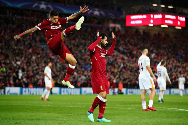 LIVERPOOL, ENGLAND - APRIL 24:  Mohamed Salah of Liverpool and teammate Roberto Firmino celebrate after scoring his sides second goal during the UEFA Champions League Semi Final First Leg match between Liverpool and A.S. Roma at Anfield on April 24, 2018 in Liverpool, United Kingdom.  (Photo by Chris Brunskill Ltd/Getty Images)