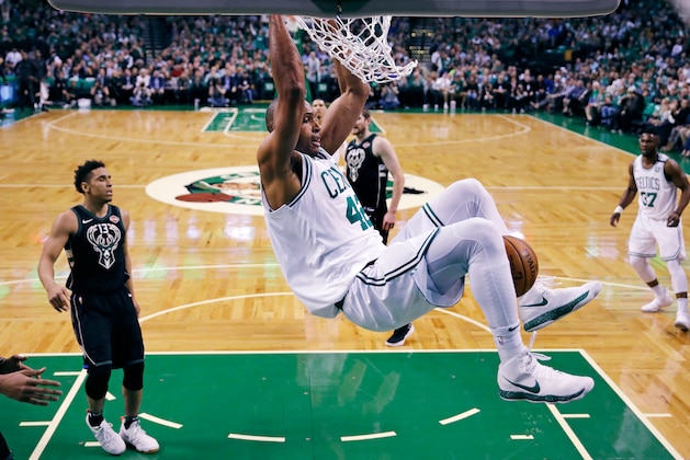 Boston Celtics forward Al Horford hangs from the rim after dunking against the Milwaukee Bucks during the first quarter of Game 5 of an NBA basketball first-round playoff series in Boston, Tuesday, April 24, 2018. (AP Photo/Charles Krupa)