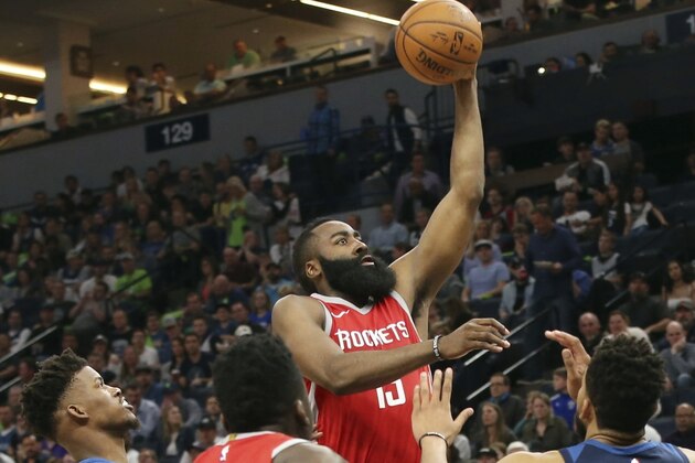 Houston Rockets' James Harden, center, shoots as Minnesota Timberwolves' Jimmy Butler, left, and Karl-Anthony Towns, right, during the second half of Game 4 in an NBA basketball first-round playoff series Monday, April 23, 2018, in Minneapolis. The Rockets won 119-100. Harden led the Rockets with 36 points. (AP Photo/Jim Mone)
