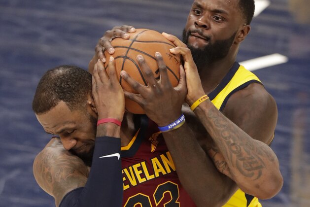 Indiana Pacers guard Lance Stephenson (1) ties up the ball with Cleveland Cavaliers forward LeBron James (23) during the second half of Game 4 of an NBA basketball first-round playoff series in Indianapolis, Sunday, April 22, 2018. (AP Photo/Michael Conroy)