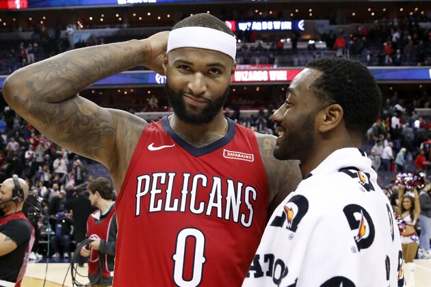 New Orleans Pelicans center DeMarcus Cousins, left, reacts as he talks with Washington Wizards guard John Wall after an NBA basketball game Tuesday, Dec. 19, 2017, in Washington. The Wizards won 116-106. (AP Photo/Alex Brandon)