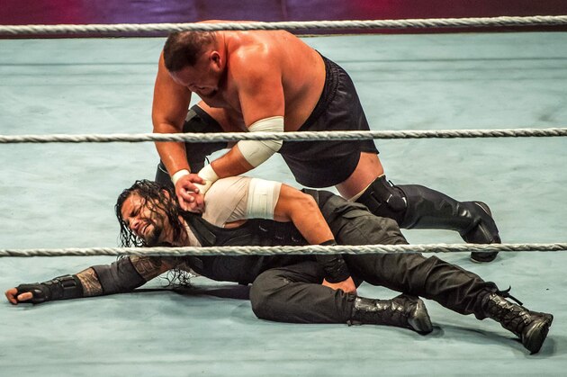 Roman and Samoa Joe (R) battle during the WWE show at Zenith Arena on may 09, 2017 in Lille, France. / AFP PHOTO / PHILIPPE HUGUEN        (Photo credit should read PHILIPPE HUGUEN/AFP/Getty Images)