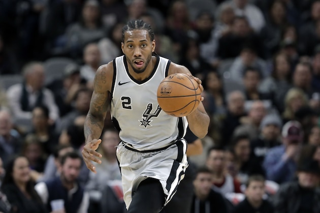 San Antonio Spurs forward Kawhi Leonard (2) moves the ball up court during the second half of an NBA basketball game against the Denver Nuggets, Saturday, Jan. 13, 2018, in San Antonio. San Antonio won 112-80. (AP Photo/Eric Gay)