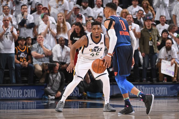SALT LAKE CITY, UT - APRIL 23: Russell Westbrook #0 of the Oklahoma City Thunder handles the ball against Donovan Mitchell #45 of the Utah Jazz  in Game Four of Round One of the 2018 NBA Playoffs on April 23, 2018 at vivint.SmartHome Arena in Salt Lake City, Utah. NOTE TO USER: User expressly acknowledges and agrees that, by downloading and/or using this Photograph, user is consenting to the terms and conditions of the Getty Images License Agreement. Mandatory Copyright Notice: Copyright 2018 NBAE (Photo by Garrett Ellwood/NBAE via Getty Images)