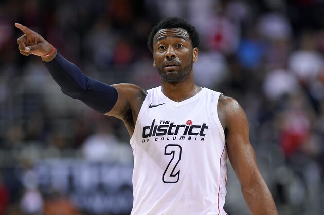 Washington Wizards guard John Wall (2) points during the second half of Game 4 of an NBA basketball first-round playoff series against the Toronto Raptors, Sunday, April 22, 2018, in Washington. The Wizards won 106-98. (AP Photo/Nick Wass)