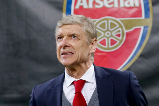 FILE - In this Thursday, March 8, 2018 file photo Arsenal's manager Arsene Wenger waits for the kick-off of the Europa League, round of 16 first-leg soccer match between AC Milan and Arsenal, at the Milan San Siro stadium, Italy. (AP Photo/Antonio Calanni, File)
