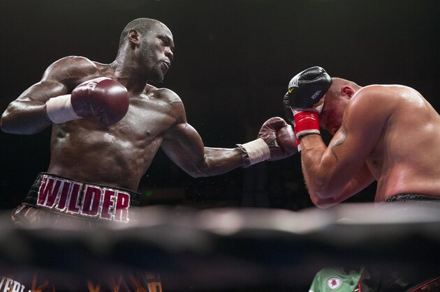 Deontay Wilder, left, punches Johann Duhaupas, of France, during a WBC heavyweight title boxing match, Saturday, Sept. 26, 2015, in Birmingham, Ala. Wilder won when the fight was stopped in the 11th round. (AP Photo/Brynn Anderson)