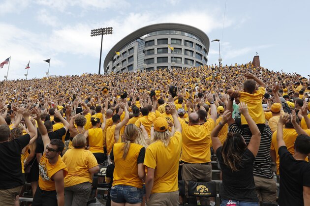 Iowa fans wave to children in the University of Iowa Stead Family Children's Hospital at the end of the first quarter of an NCAA college football game against North Texas, Saturday, Sept. 16, 2017, in Iowa City, Iowa. (AP Photo/Charlie Neibergall)