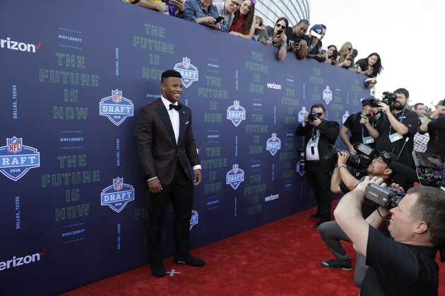 Penn State's Saquon Barkley poses on the red carpet before the first round of the 2018 NFL football draft, Thursday, April 26, 2018, in Arlington, Texas. (AP Photo/Eric Gay)