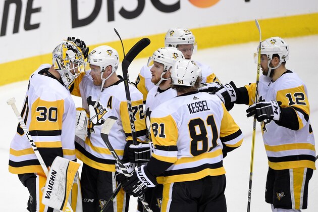 Pittsburgh Penguins goaltender Matt Murray (30) celebrates with right wing Patric Hornqvist (72), of Sweden; right wing Phil Kessel (81); center Dominik Simon (12); and others after Game 1 of an NHL second-round hockey playoff series against the Washington Capitals, Thursday, April 26, 2018, in Washington. The Penguins won 3-2. (AP Photo/Nick Wass)