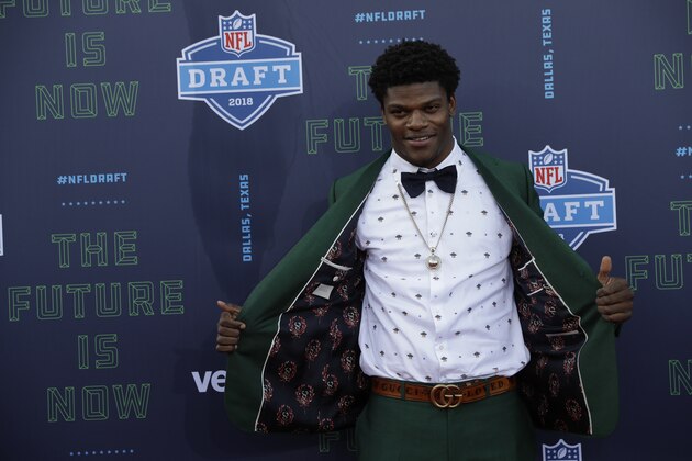 Louisville's Lamar Jackson poses for photos on the red carpet before the first round of the 2018 NFL football draft, Thursday, April 26, 2018, in Arlington, Texas. (AP Photo/Eric Gay)