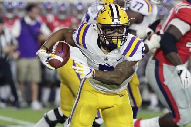 LSU running back Derrius Guice (5) runs through Mississippi defenders for a long gain in the first half of an NCAA college football game in Oxford, Miss., Saturday, Oct. 21, 2017. No. 24 LSU won 40-24. (AP Photo/Rogelio V. Solis)