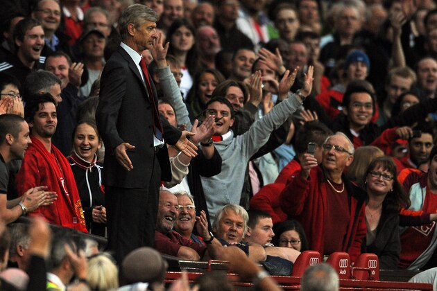 Arsenal's French manager Arsene Wenger gestures to the referee from the stands after being sent off during the English Premier League football match between Manchester United and Arsenal at Old Trafford in Manchester, north-west England, on August 29, 2009. AFP PHOTO/PAUL ELLIS -  FOR EDITORIAL USE ONLY Additional licence required for any commercial/promotional use or use on TV or internet (except identical online version of newspaper) of Premier League/Football League photos. Tel DataCo +44 207 2981656. Do not alter/modify photo.  (Photo credit should read PAUL ELLIS/AFP/Getty Images)