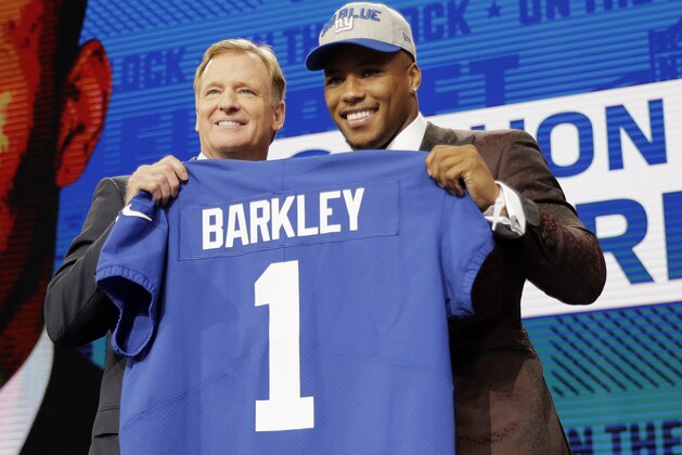 Penn State's Saquon Barkley, right, poses with commissioner Roger Goodell after being selected by the New York Giants during the first round of the NFL football draft, Thursday, April 26, 2018, in Arlington, Texas. (AP Photo/David J. Phillip)