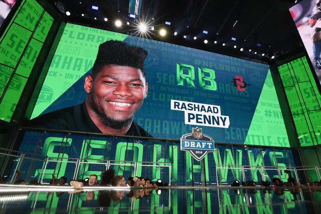 ARLINGTON, TX - APRIL 26:  A video board displays an image of Rashaad Penny of San Diego State after he was picked #27 overall by the Seattle Seahawks during the first round of the 2018 NFL Draft at AT&T Stadium on April 26, 2018 in Arlington, Texas.  (Photo by Ronald Martinez/Getty Images)