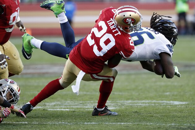 San Francisco 49ers strong safety Jaquiski Tartt (29) tackles Seattle Seahawks running back Alex Collins during the second half of an NFL football game in Santa Clara, Calif., Sunday, Jan. 1, 2017. (AP Photo/Tony Avelar)