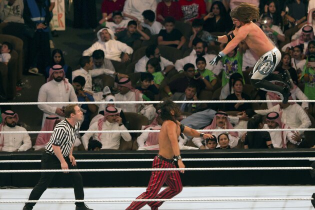 World Wrestling Entertainment stars AJ Styles, top, and Shinsuke Nakamura, wrestle during their match at the