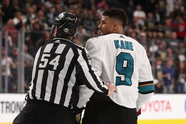 GLENDALE, NV - APRIL 26:  Evander Kane #9 of the San Jose Sharks is escorted off the ice by linesman Greg Devorski #54 after a 5 minute major penalty and game misconduct in the third period Game One of the Western Conference Second Round against the Vegas Golden Knights during the 2018 NHL Stanley Cup Playoffs at T-Mobile Arena on April 26, 2018 in Las Vegas, Nevada. The Golden Knights defeated the Sharks 7-0.  (Photo by Christian Petersen/Getty Images)