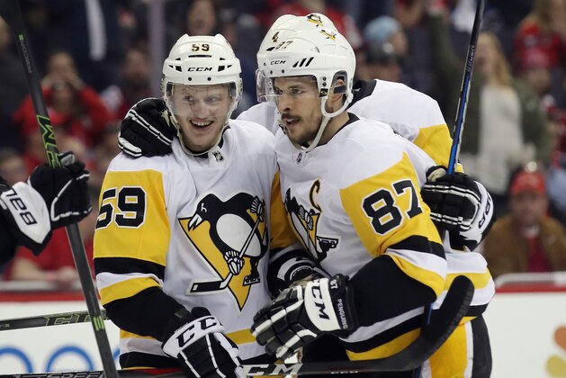 WASHINGTON, DC - APRIL 26: Jake Guentzel #59 of the Pittsburgh Penguins (l) celebrates his game winning goal at 7:48 of the third period against the Washington Capitals and is joined by Sidney Crosby #87 (r) in Game One of the Eastern Conference Second Round during the 2018 NHL Stanley Cup Playoffs at the Capital One Arena on April 26, 2018 in Washington, DC. The Penguins defeated the Capitals 3-2. (Photo by Bruce Bennett/Getty Images)