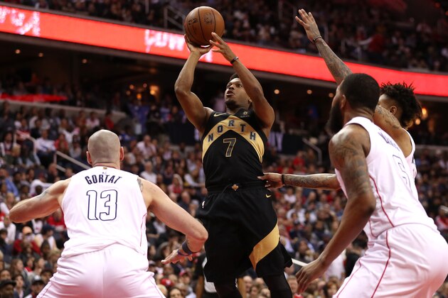 WASHINGTON, DC - APRIL 27: Kyle Lowry #7 of the Toronto Raptors shoots in front of Marcin Gortat #13 of the Washington Wizards in the first half during Game Six of Round One of the 2018 NBA Playoffs at Capital One Arena on April 27, 2018 in Washington, DC. NOTE TO USER: User expressly acknowledges and agrees that, by downloading and or using this photograph, User is consenting to the terms and conditions of the Getty Images License Agreement. (Photo by Patrick Smith/Getty Images)