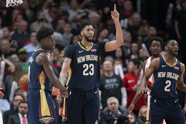 New Orleans Pelicans guard Jrue Holiday, forward Anthony Davis and guard Ian Clark celebrate a score against the Portland Trail Blazers during the second half in Game 1 of an NBA basketball first-round playoff series Saturday, April 14, 2018, in Portland, Ore. New Orleans won 97-95. (AP Photo/Randy L. Rasmussen)