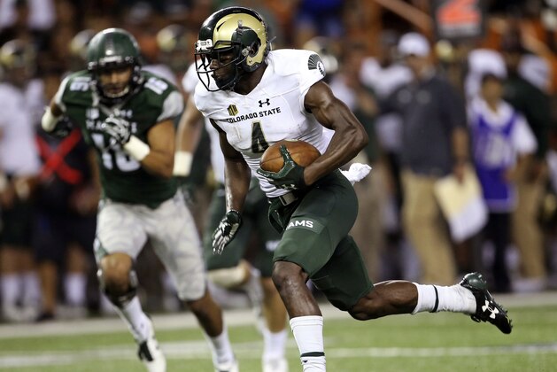 FILE - In this Sept. 30, 2017, file photo, Colorado State wide receiver Michael Gallup (4) heads tot he endzone to score a touchdown against Hawaii during the third quarter of an NCAA college football game in Honolulu. Gallup leads the nation with 1,298 yards receiving. (AP Photo/Marco Garcia, File)