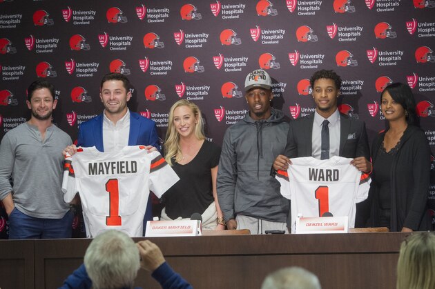 Cleveland Browns first-round pick Baker Mayfield, second from left, stands with his brother Matt Mayfield, left, and girlfriend, Emily Wilkinson along with fellow first-round pick Denzel Ward, second from right, with his brother Paul Ward III and his mother, Nicole Ward, far right, after a news conference at the Browns headquarters in Berea, Ohio, Friday, April 27, 2018. Mayfield was the first selection in the draft, Ward the fourth. (AP Photo/Phil Long)