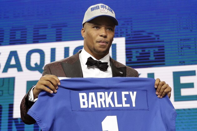 Penn State's Saquon Barkley poses for photos with his New York Giants team jersey during the first round of the NFL football draft, Thursday, April 26, 2018, in Arlington, Texas. (AP Photo/David J. Phillip)