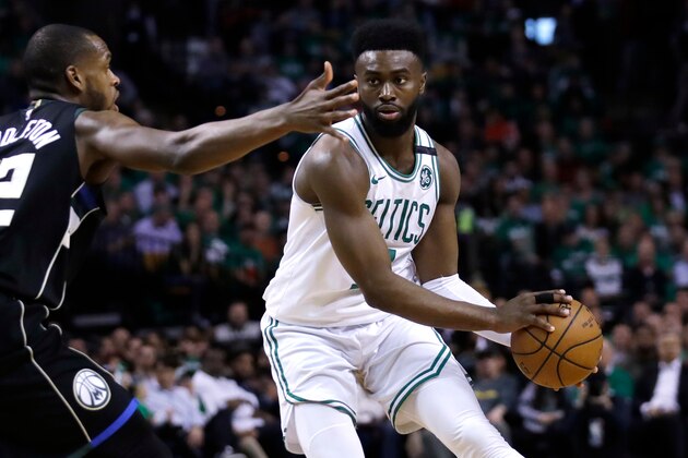 Boston Celtics guard Jaylen Brown, right, looks to pass as he is pressured by Milwaukee Bucks forward Khris Middleton (22) during Game 2 of an NBA basketball first-round playoff series in Boston, Tuesday, April 17, 2018. The Celtics defeated the Bucks 120-106. (AP Photo/Charles Krupa)