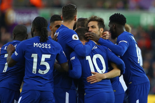 Chelsea's Spanish midfielder Cesc Fabregas (2nd R) celebrates with teammates after scoring the opening goal of the English Premier League football match between Swansea City and Chelsea at The Liberty Stadium in Swansea, south Wales on April 28, 2018. (Photo by Geoff CADDICK / AFP) / RESTRICTED TO EDITORIAL USE. No use with unauthorized audio, video, data, fixture lists, club/league logos or 'live' services. Online in-match use limited to 75 images, no video emulation. No use in betting, games or single club/league/player publications. /         (Photo credit should read GEOFF CADDICK/AFP/Getty Images)