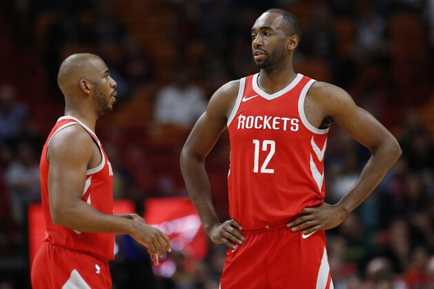 Houston Rockets forward Luc Mbah a Moute (12) and guard Chris Paul talk during the first half of an NBA basketball game against the Miami Heat, Wednesday, Feb. 7, 2018, in Miami. (AP Photo/Wilfredo Lee)