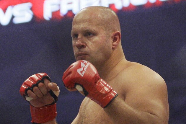 FILE - In this June 26, 2010, file photo, Fedor Emelianenko, of Russia, fights Fabricio Werdum in a Strikeforce/M-1 Global mixed martial arts match in San Jose, Calif. Emelianenko doesn't speak a lick of English. He rarely smiles. When he steps inside a ring or cage, he looks like he's bored, like he'd rather be reading a book. Here's why fans wait hours to see him, though: He just may be the best heavyweight fighter ever. (AP Photo/Jeff Chiu, File)