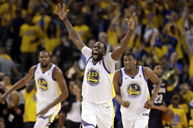 Golden State Warriors' Draymond Green (23) reacts after feeding an alley-oop pass for a dunk by Kevin Durant, left, during the first half in Game 1 of an NBA basketball second-round playoff series Saturday, April 28, 2018, in Oakland, Calif. (AP Photo/Marcio Jose Sanchez)