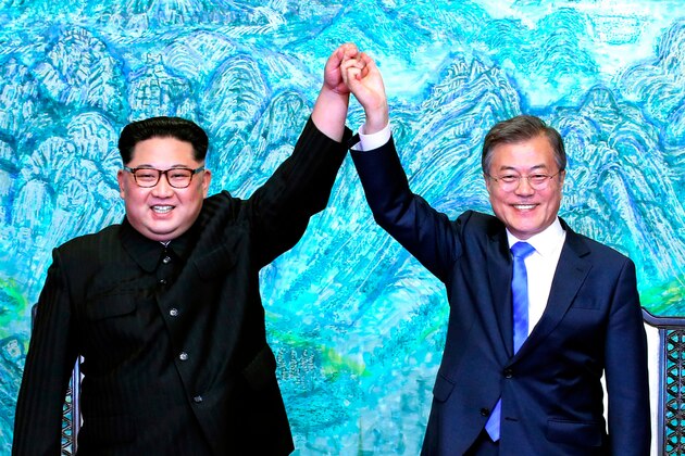 FILE - In this April 27, 2018 file photo, North Korean leader Kim Jong Un, left, and South Korean President Moon Jae-in raise their hands after signing a joint statement at the border village of Panmunjom in the Demilitarized Zone, South Korea. Despite its feel-good emphasis on relationship-building, the first inter-Korean summit in more than a decade left a lot of question marks around the biggest and most contentious agenda item of them all: denuclearization. And that puts the ball squarely in the court of President Donald Trump, whose much anticipated sit-down with Kim is expected to be just weeks away. (Korea Summit Press Pool via AP, File)