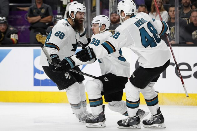 San Jose Sharks' Logan Couture (39) celebrates after scoring the game-winning goal against the Vegas Golden Knights during the second overtime of Game 2 of an NHL hockey second-round playoff series Saturday, April 28, 2018, in Las Vegas. Sharks' Brent Burns (88) and Tomas Hertl (48) celebrate with Couture. San Jose won 4-3. (AP Photo/John Locher)