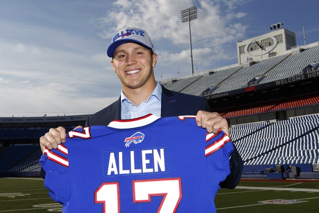 Buffalo Bills first-round draft Josh Allen poses with his jersey during his introductory NFL football news conference at New Era Field, Friday, April 27, 2018, in Orchard Park, N.Y. (AP Photo/Jeffrey T. Barnes)