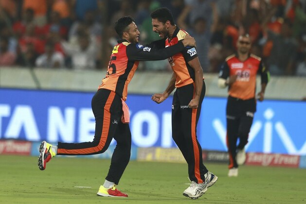 Sunrisers Hyderabad bowler Basil Thampi,right, celebrates the wicket of Chris Gayle with Shakib Al Hasan during VIVO IPL cricket T20 match against Kings XI Punjab in Hyderabad, India, Thursday, April 26, 2018. (AP Photo/Mahesh Kumar A.)
