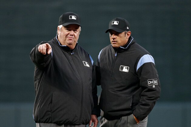 Umpires Joe West, left, and umpire Mark Ripperger chat before a baseball game between the Baltimore Orioles and the Minnesota Twins, Saturday, March 31, 2018, in Baltimore. (AP Photo/Patrick Semansky)