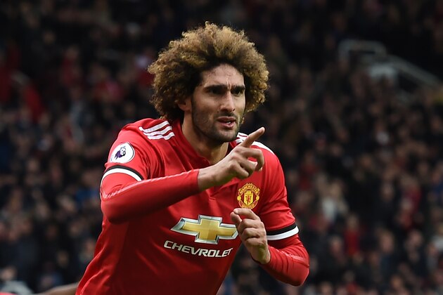 Manchester United's Belgian midfielder Marouane Fellaini celebrates after scoring their late second goal during the English Premier League football match between Manchester United and Arsenal at Old Trafford in Manchester, north west England, on April 29, 2018. - Manchester United won the game 2-1. (Photo by Paul ELLIS / AFP) / RESTRICTED TO EDITORIAL USE. No use with unauthorized audio, video, data, fixture lists, club/league logos or 'live' services. Online in-match use limited to 75 images, no video emulation. No use in betting, games or single club/league/player publications. /         (Photo credit should read PAUL ELLIS/AFP/Getty Images)