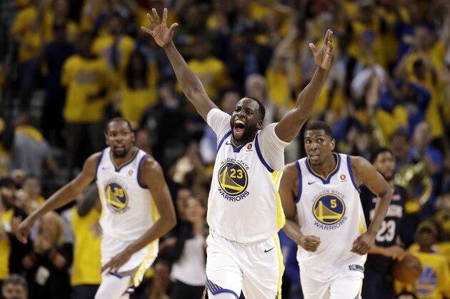 Golden State Warriors' Draymond Green (23) reacts after feeding an alley-oop pass for a dunk by Kevin Durant, left, during the first half in Game 1 of an NBA basketball second-round playoff series Saturday, April 28, 2018, in Oakland, Calif. (AP Photo/Marcio Jose Sanchez)