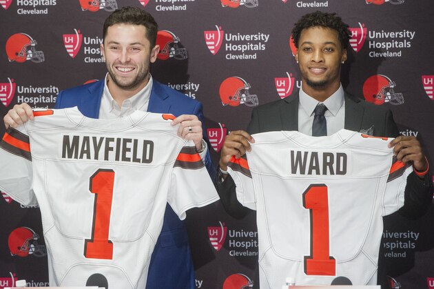 Cleveland Browns first round draftees Baker Mayfield and Denzel Ward hold their jerseys after a news conference at the Browns headquarters in Berea, Ohio, Friday, April 27, 2018. Mayfield was the first pick in the draft, Ward the fourth. (AP Photo/Phil Long)