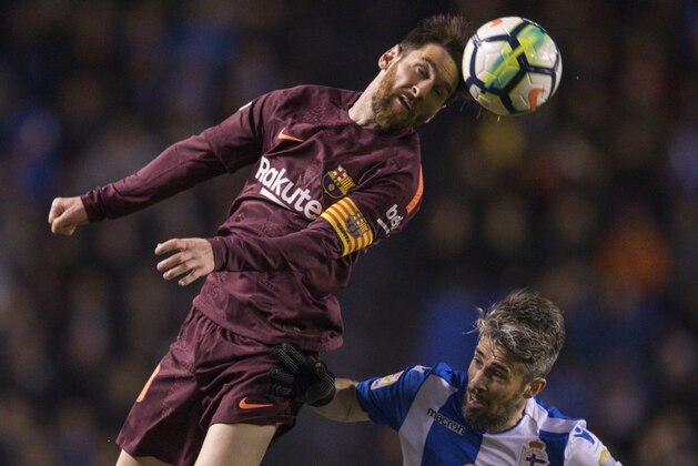 Barcelona's Lionel Messi, left, challenges for the ball with Deportivo's Luisinho during a Spanish La Liga soccer match between Deportivo and Barcelona at the Riazor stadium in A Coruna, Spain, Sunday, April 29, 2018. (AP Photo/Lalo R. Villar) Barcelona's Lionel Messi, left, challenges for the ball with Deportivo's Luisinho during a Spanish La Liga soccer match between Deportivo and Barcelona at the Riazor stadium in A Coruna, Spain, Sunday, April 29, 2018. (AP Photo/Lalo R. Villar)