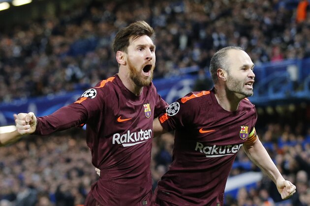 Barcelona's Lionel Messi celebrates with Andres Iniesta scoring his side's first goal during a Champions League round of sixteen first leg soccer match between FC Barcelona and Chelsea at Stamford Bridge stadium in London, Tuesday, Feb. 20, 2018. (AP Photo/Alastair Grant)